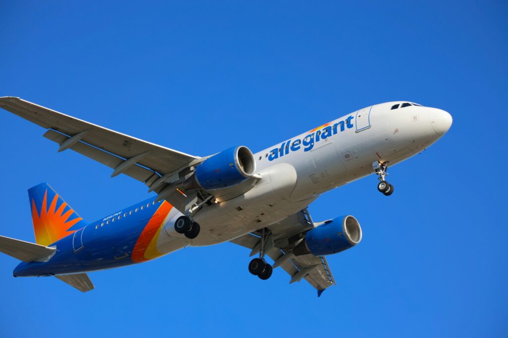 A large passenger jet flying through the blue sky